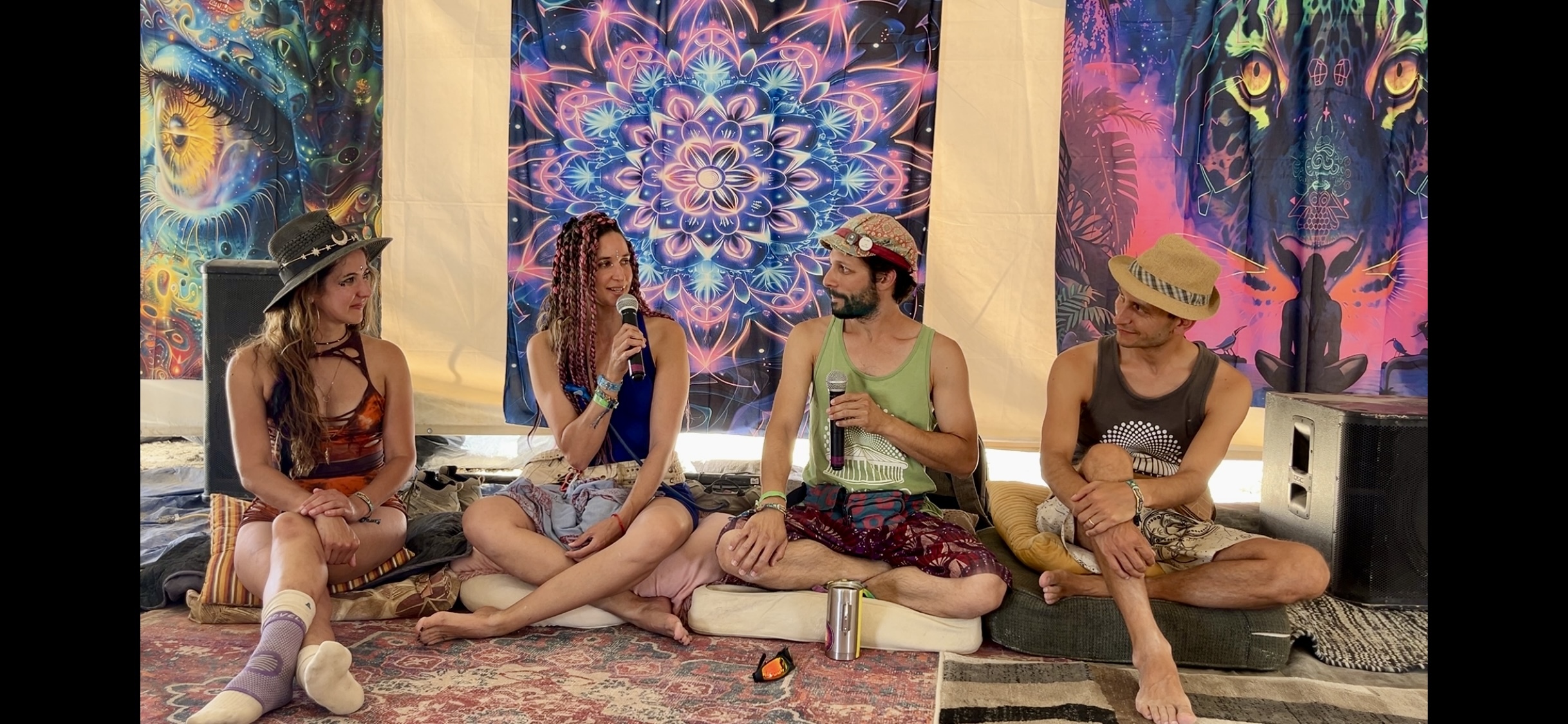 Zendo Project staff and volunteers sit in a semicircle at their panel on harm reduction at Burning Man 2024.